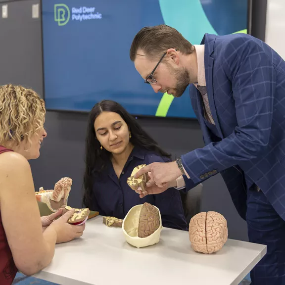 instructor with student and brain model