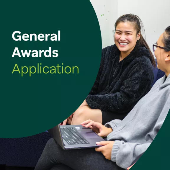 Two female students smile at each other. Text over screen reads "General Awards Application"